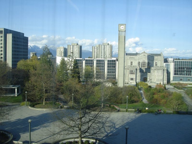 View from Koerner Library window showing UBC campus and mountains in background.