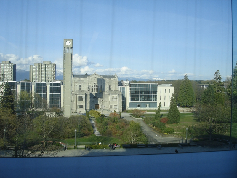 View from Koerner Library window showing UBC campus and mountains in background.